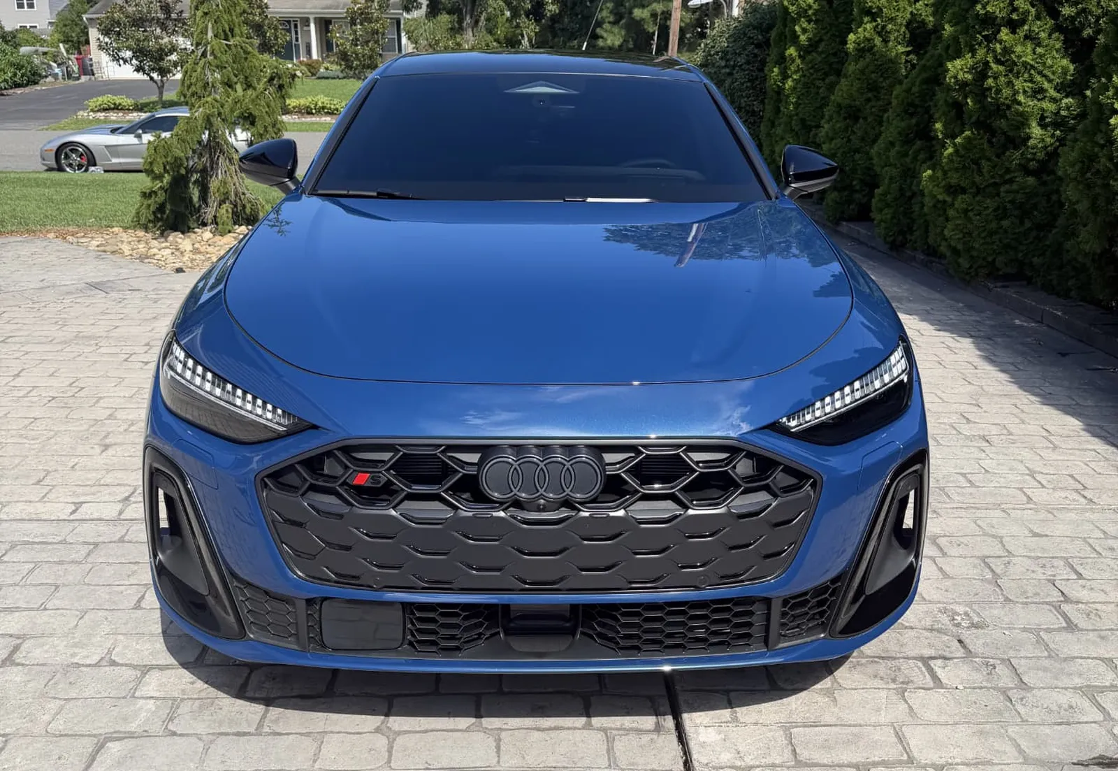 Freshly detailed black performance car inside the Motor Shine Garage detailing bay